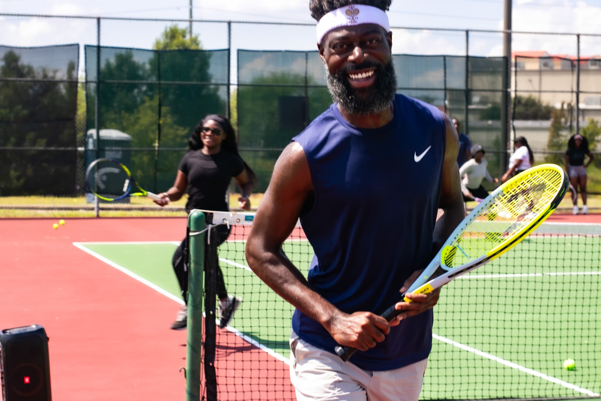 Elite Aces tennis players on court during a social session.